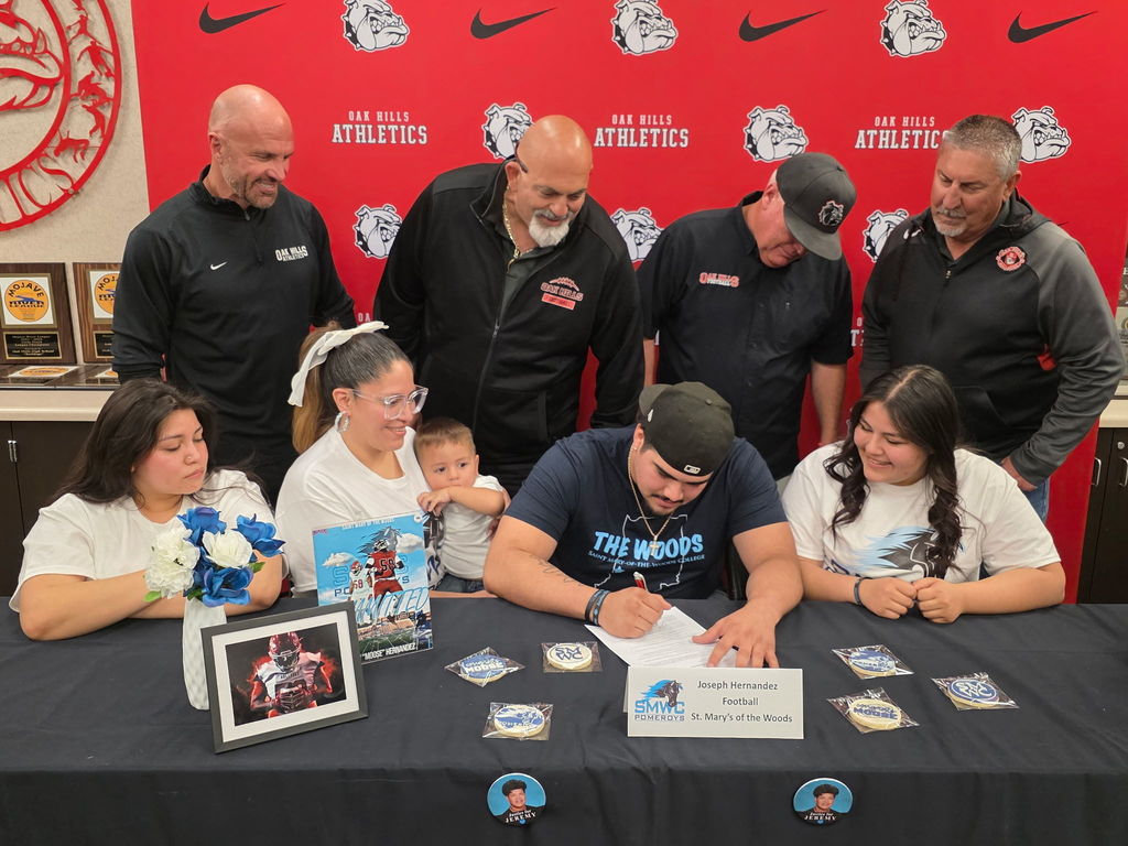 Oak Hills High School proudly celebrates one of its finest as star football standout Joseph “Moose” Hernandez takes the next step in his journey, signing with St. Mary’s of the Woods!  A true force on the field, Moose was a cornerstone of Bulldog football, bringing power, grit, and relentless determination every Friday night. His impact helped drive Oak Hills to an incredible milestone: the program’s 5th consecutive Mojave River League Championship, cementing his legacy as part of a dominant era.  Moose, your hard work, leadership, and passion have set the standard. The entire Bulldog community is behind you as you head to Indiana to continue your academic and athletic career.  It's a great day to be a Bulldog!