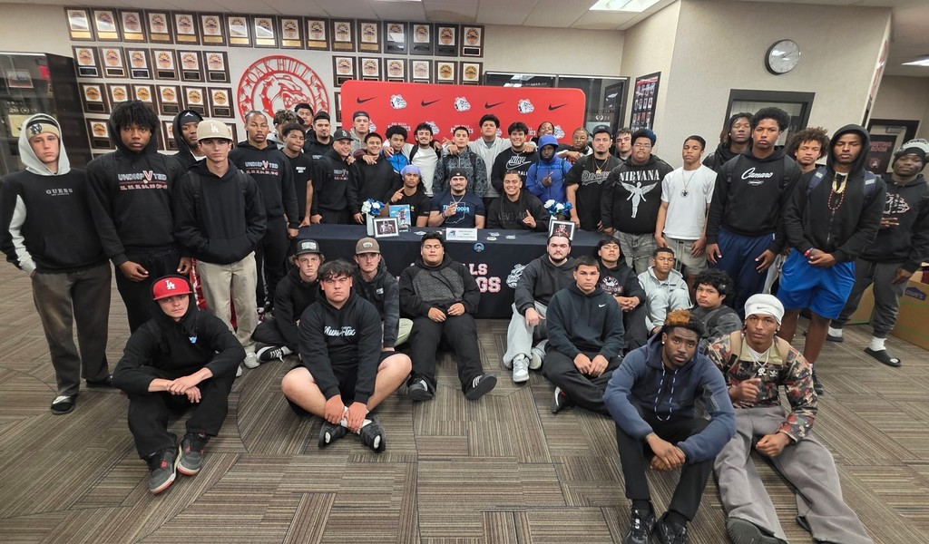 staff and teammates at the signing with Joseph