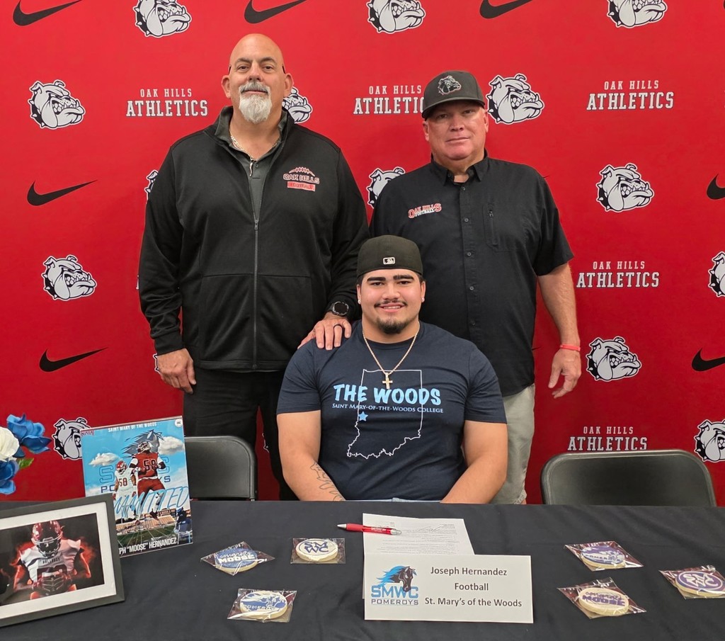 staff and teammates at the signing with Joseph