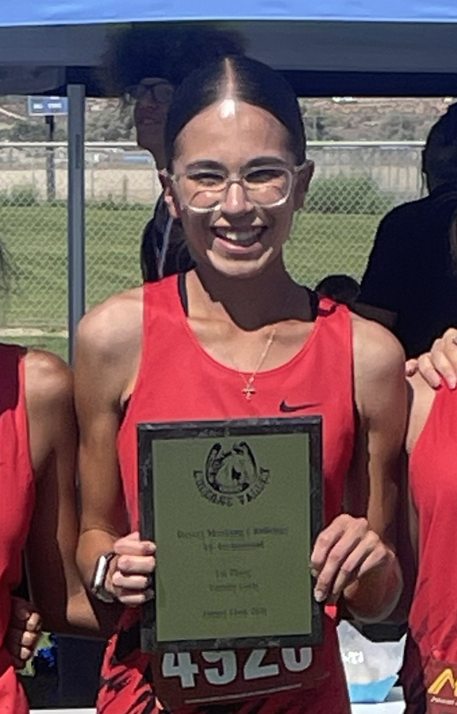 Student Belen Gonzalez holding an award.