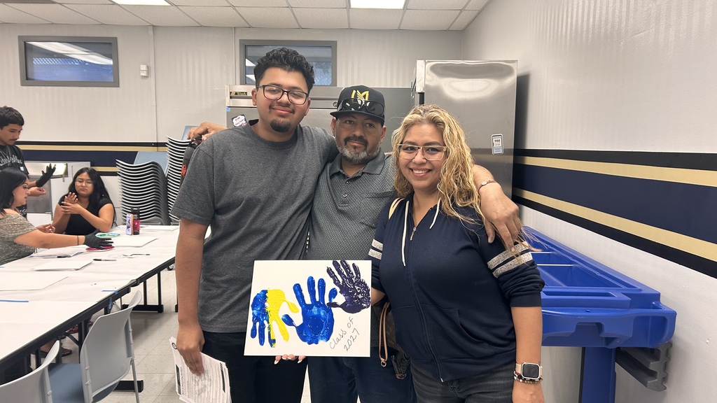 Family holding handprint painting