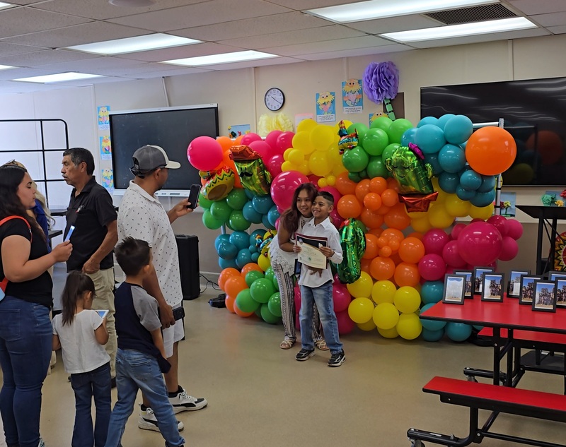 Parents, students, and staff coming together to celebrate our DLI program