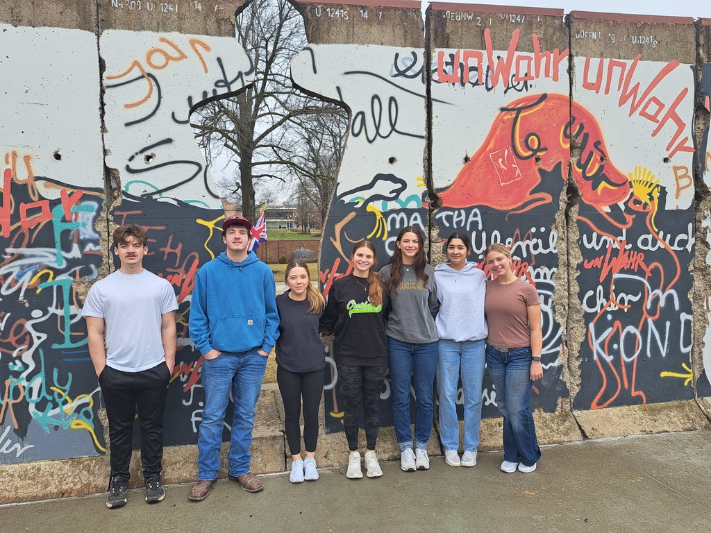 Students with portion of Berlin wall