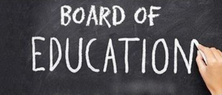chalk board that says Board of Education with hand