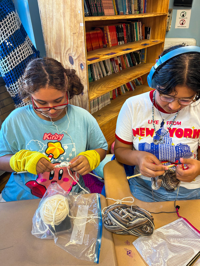 Friends teaching friends to knit.