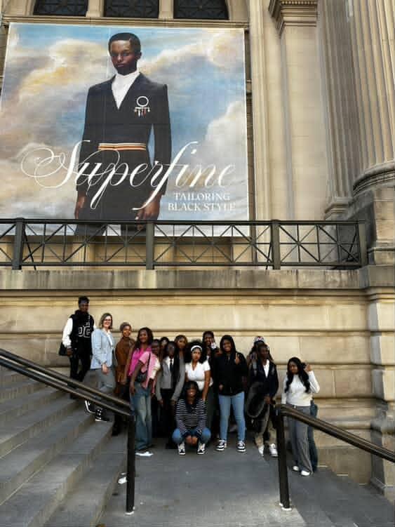 Poster advertising the "Superfine: Tailoring Black Style" exhibition outside of the MET.