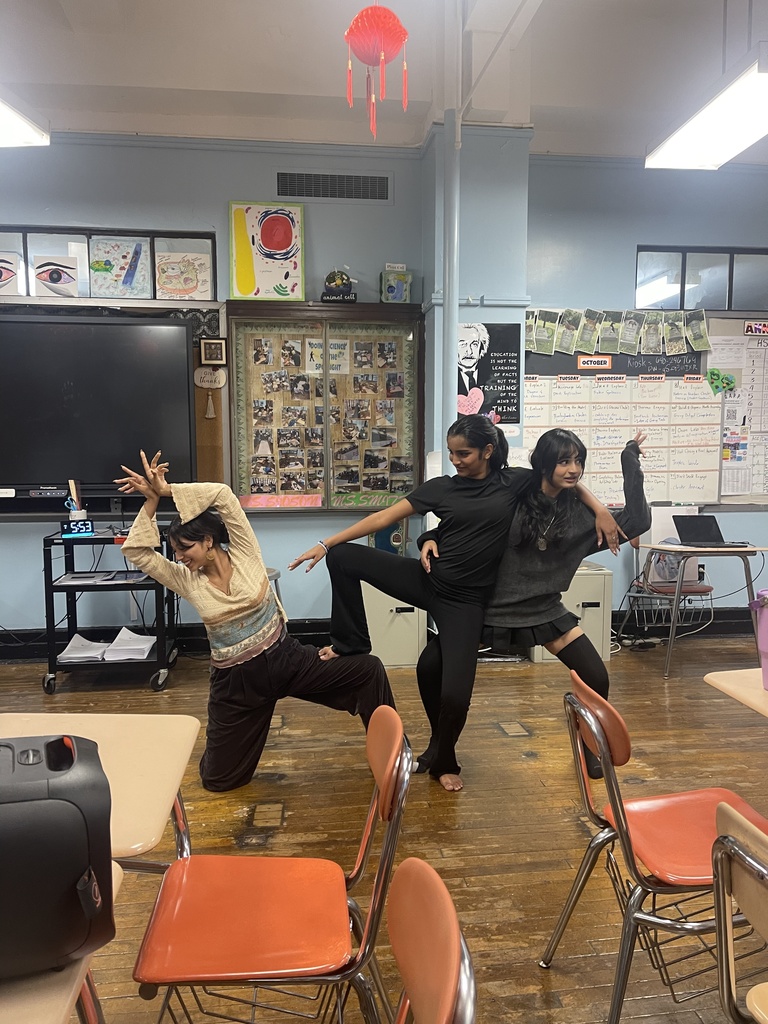 Desi dance team figuring out their final pose for the dance