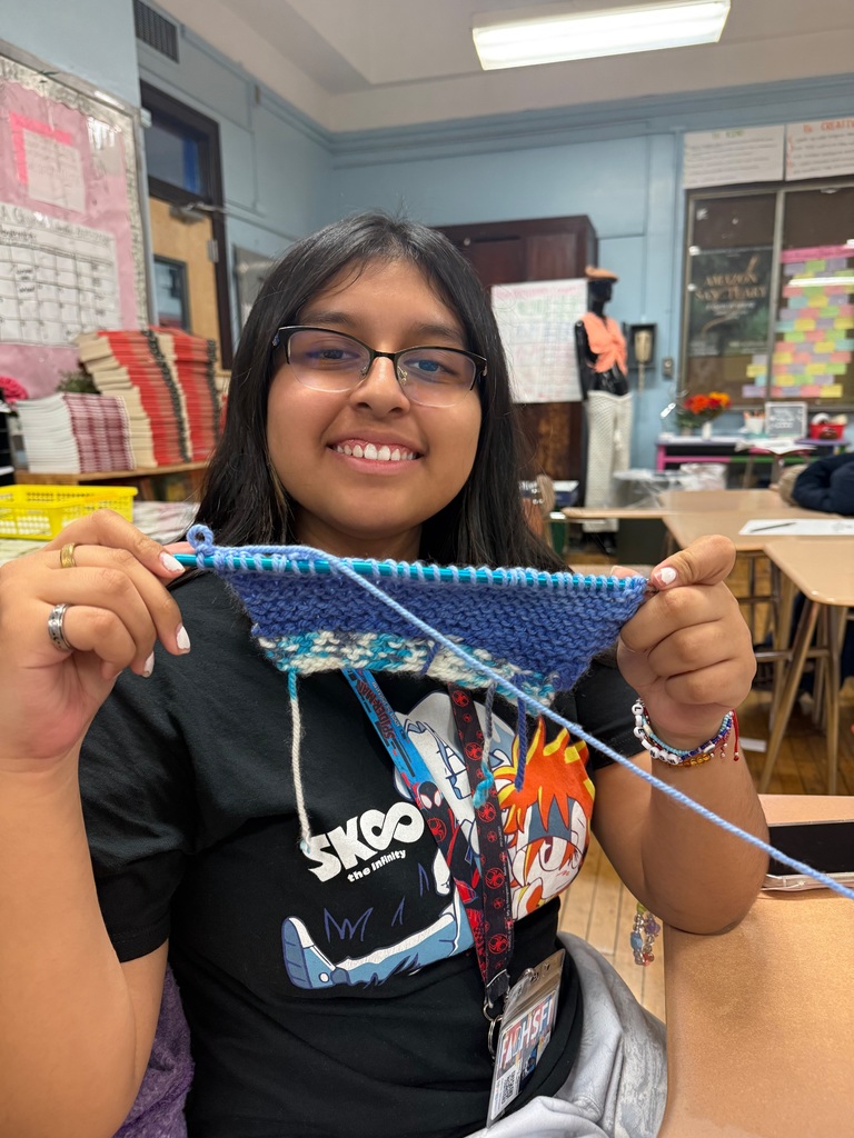 Student knitting blue yarn and it looking great! 