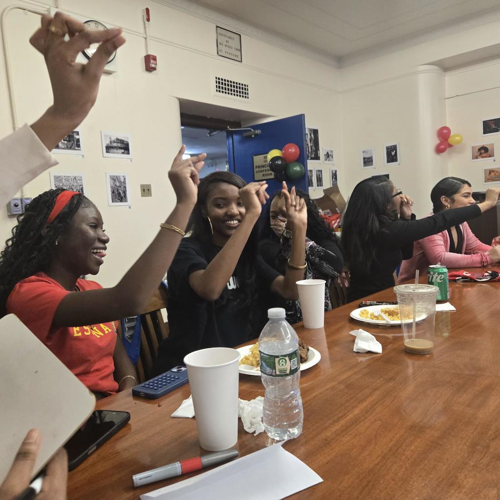 Members of team "Tea" celebrate getting the correct answer.