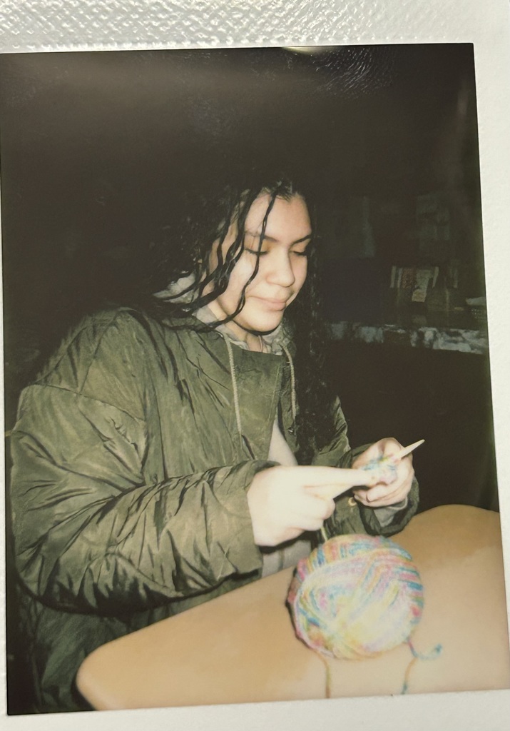 Student knitting with colorful yarn 