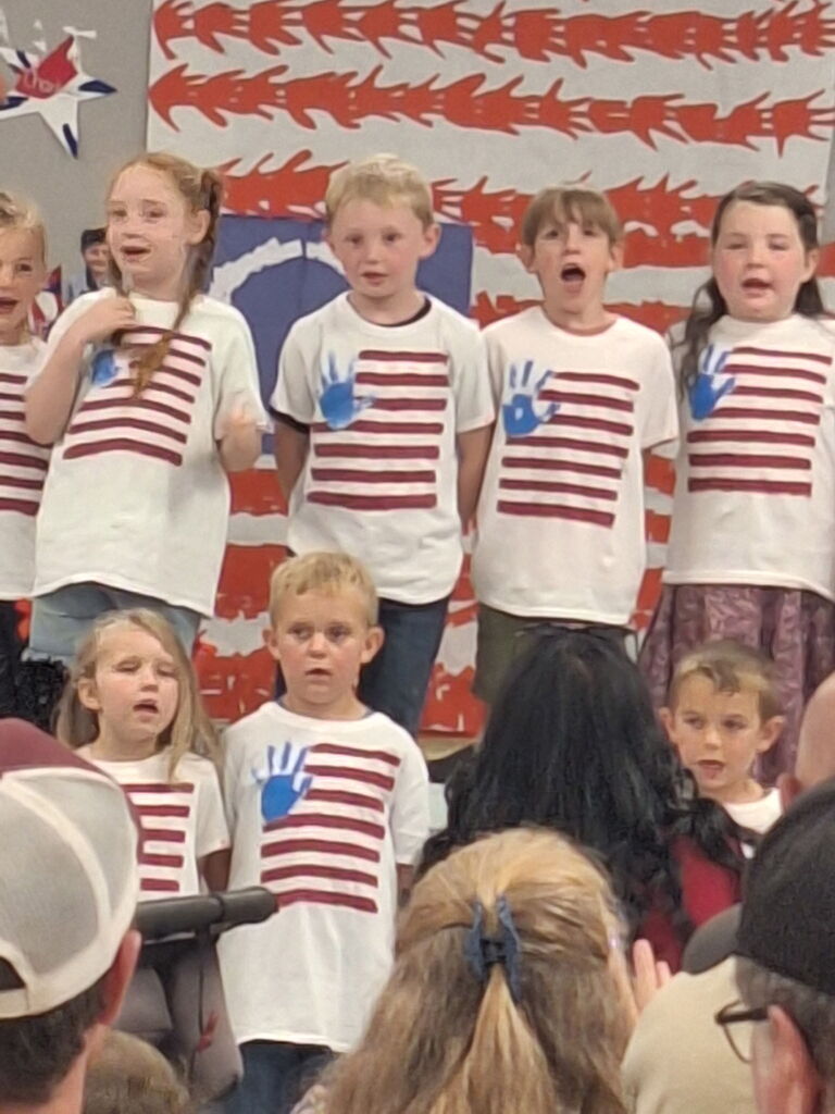 Our kindergarten students truly had a night to shine at HES! Families gathered for a picnic dinner before enjoying a wonderful performance by the children.  In celebration of our nation's 250th anniversary, the students proudly recited selections from The Flag We Love by Judi Harris and sang several beloved American songs. The program also featured students portraying historical figures from our SOL studies, bringing history to life for the audience.  The evening included a retelling of the classic tale The Three Billy Goats Gruff, followed by a fun and humorous twist with The Three Silly Girls Grubb by John and Ann Hassett.  The children did an amazing job showcasing their learning, confidence, and creativity. Thank you to all the families who attended and supported this special event. It was a memorable evening filled with smiles, laughter, and pride in all our young learners! 🌟🇺🇸📚🎶