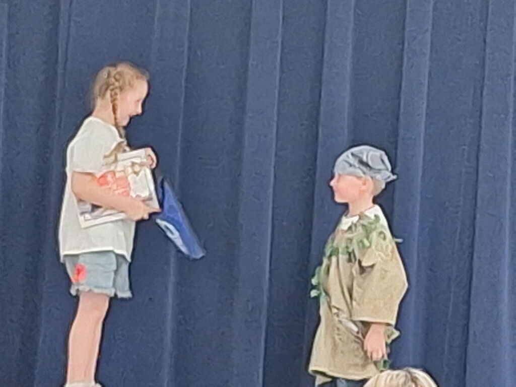 Our kindergarten students truly had a night to shine at HES! Families gathered for a picnic dinner before enjoying a wonderful performance by the children.  In celebration of our nation's 250th anniversary, the students proudly recited selections from The Flag We Love by Judi Harris and sang several beloved American songs. The program also featured students portraying historical figures from our SOL studies, bringing history to life for the audience.  The evening included a retelling of the classic tale The Three Billy Goats Gruff, followed by a fun and humorous twist with The Three Silly Girls Grubb by John and Ann Hassett.  The children did an amazing job showcasing their learning, confidence, and creativity. Thank you to all the families who attended and supported this special event. It was a memorable evening filled with smiles, laughter, and pride in all our young learners! 🌟🇺🇸📚🎶