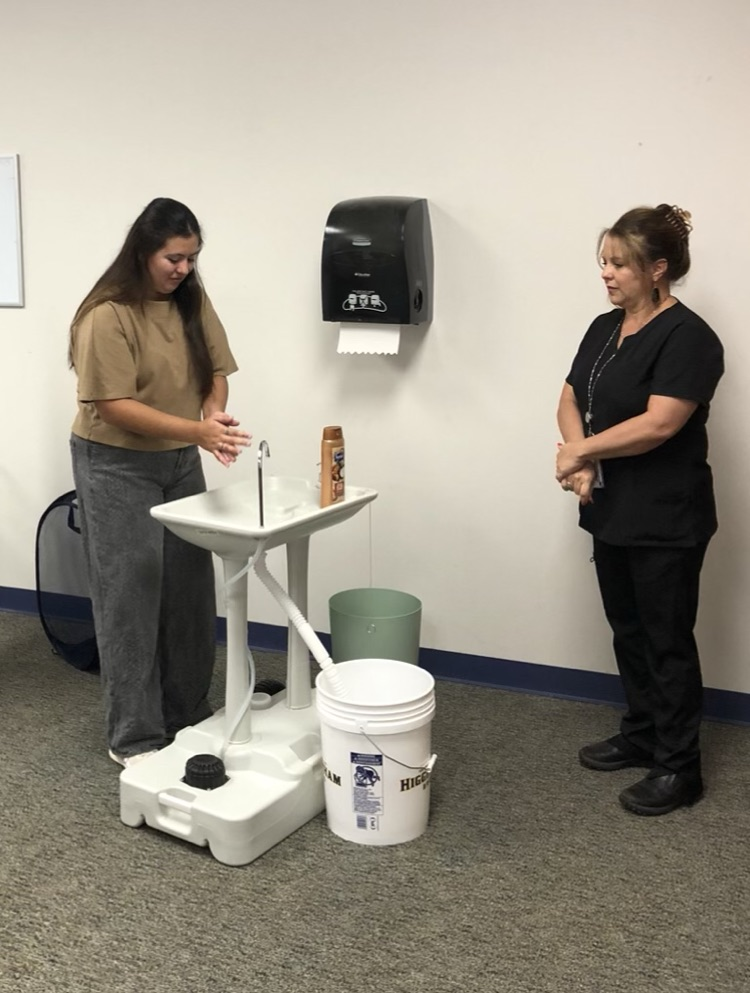 student washing hands