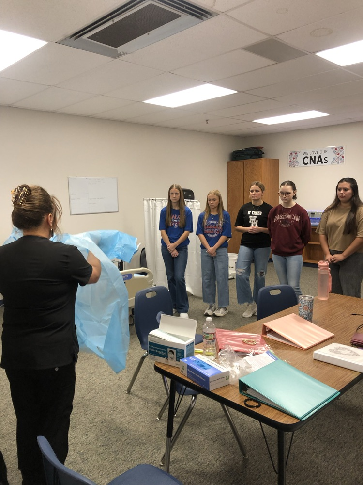 nurse demonstrating PPE