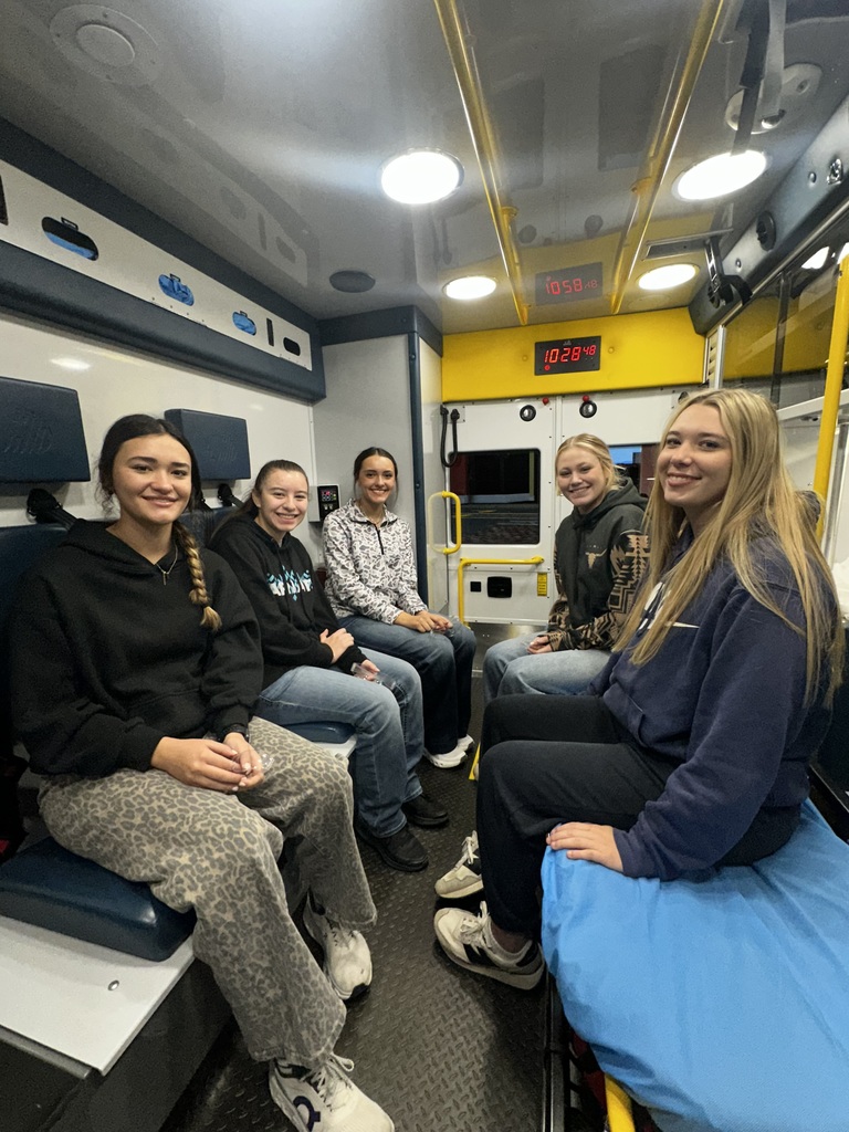 Students sitting in an ambulance