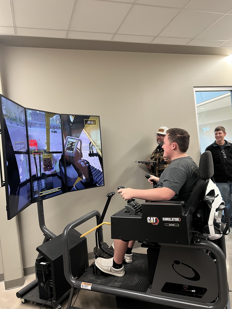 Student driving a excavator simulator