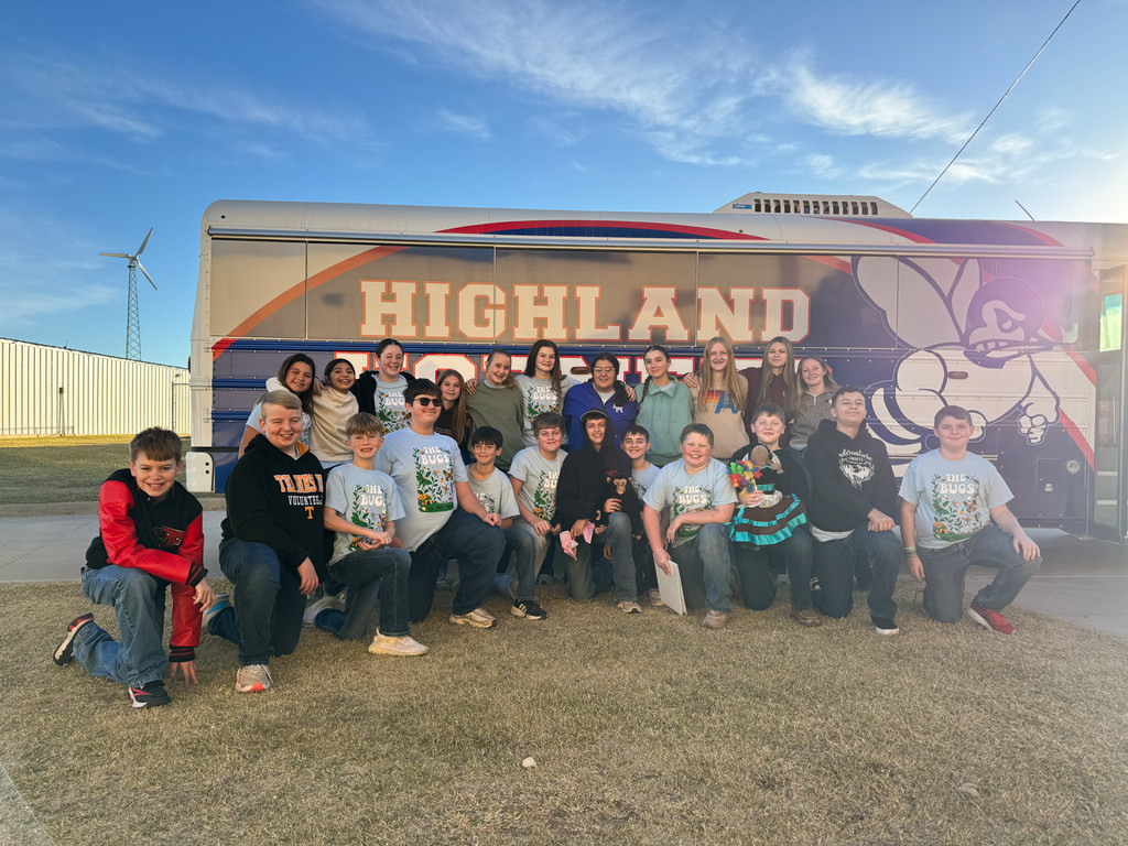 JH OAP students standing in front of bus