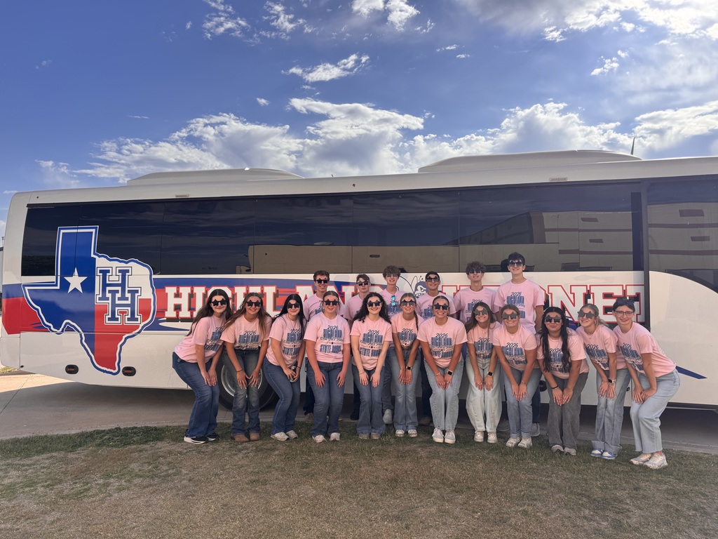 HS OAP students posing in front of bus.