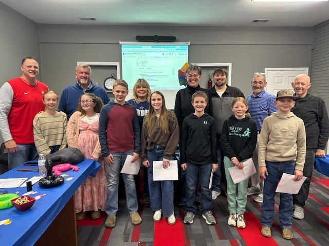 School Board members pose with 5th grade students 