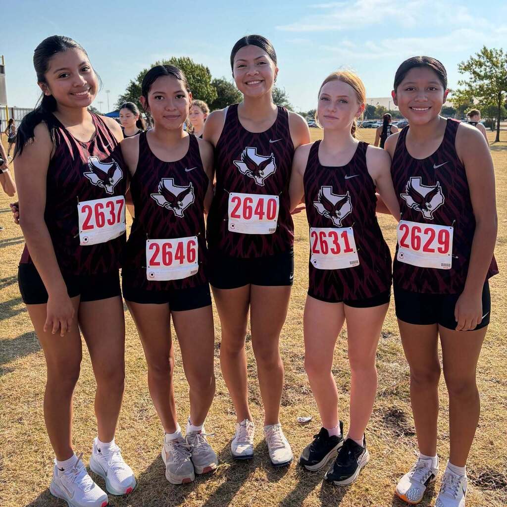 Five Cross Country Athletes Smiling for a Photo
