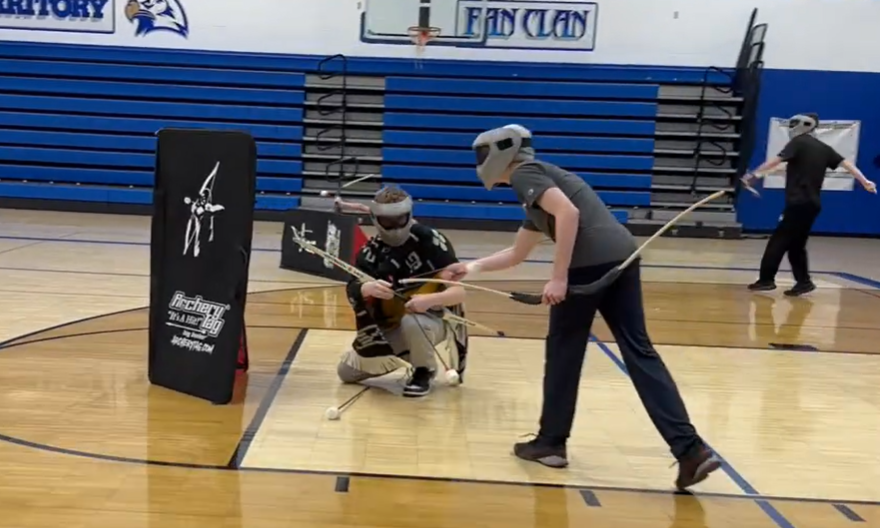Students playing Archery Tag at the high school.