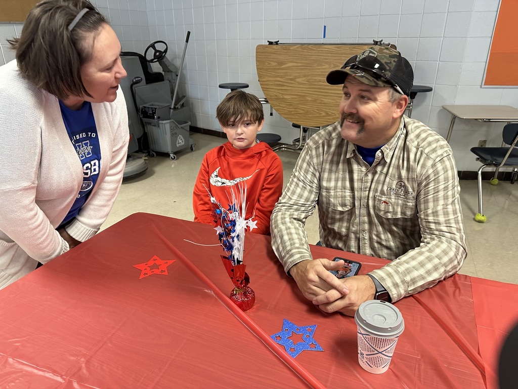 A teacher speaks with a veteran at our jr. high breakfast and assembly honoring hillsboro veterans