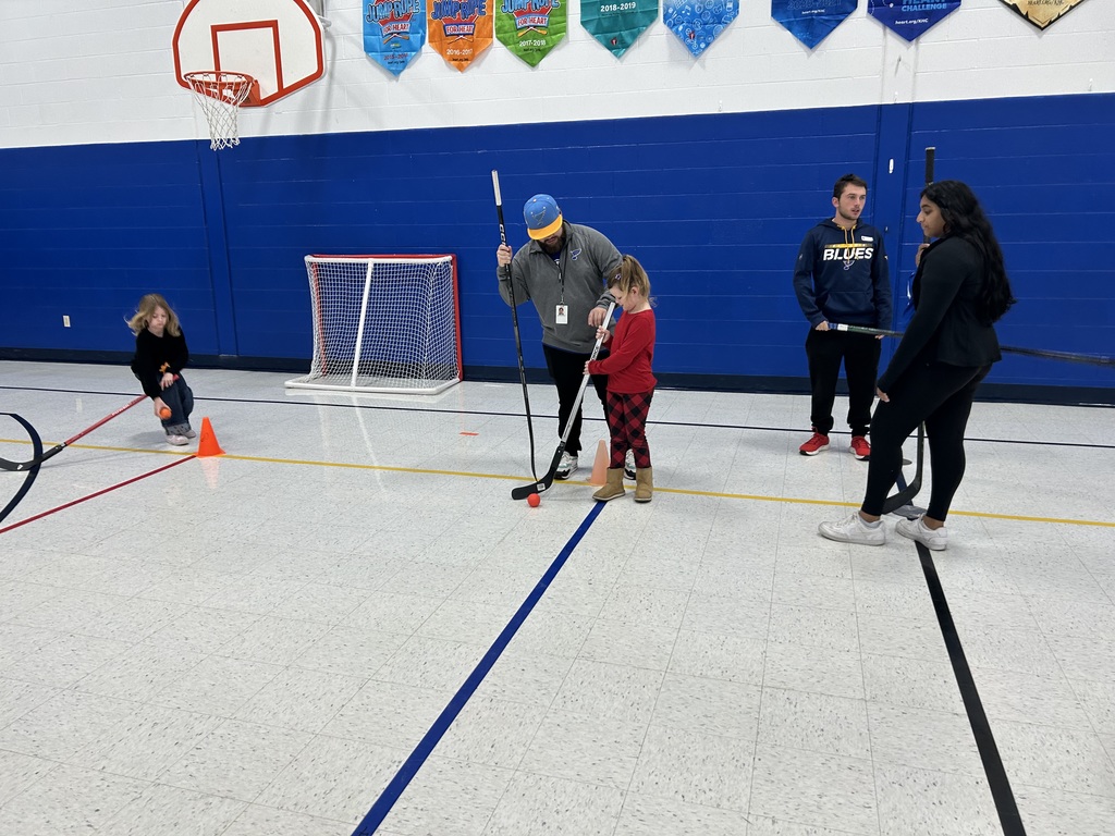 A student learns how to handle a hockey stick during a visit from the St. Louis Blues Street Team. 
