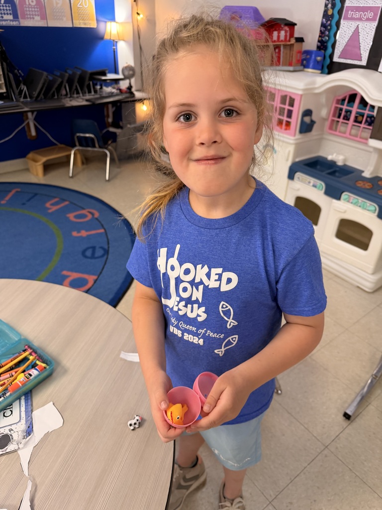 Student holding an easter egg with a toy baby chick inside