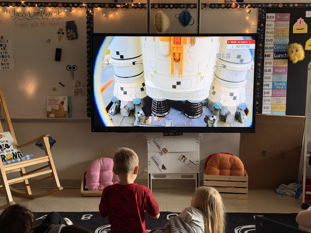 Primary school students watching the artemis mission live