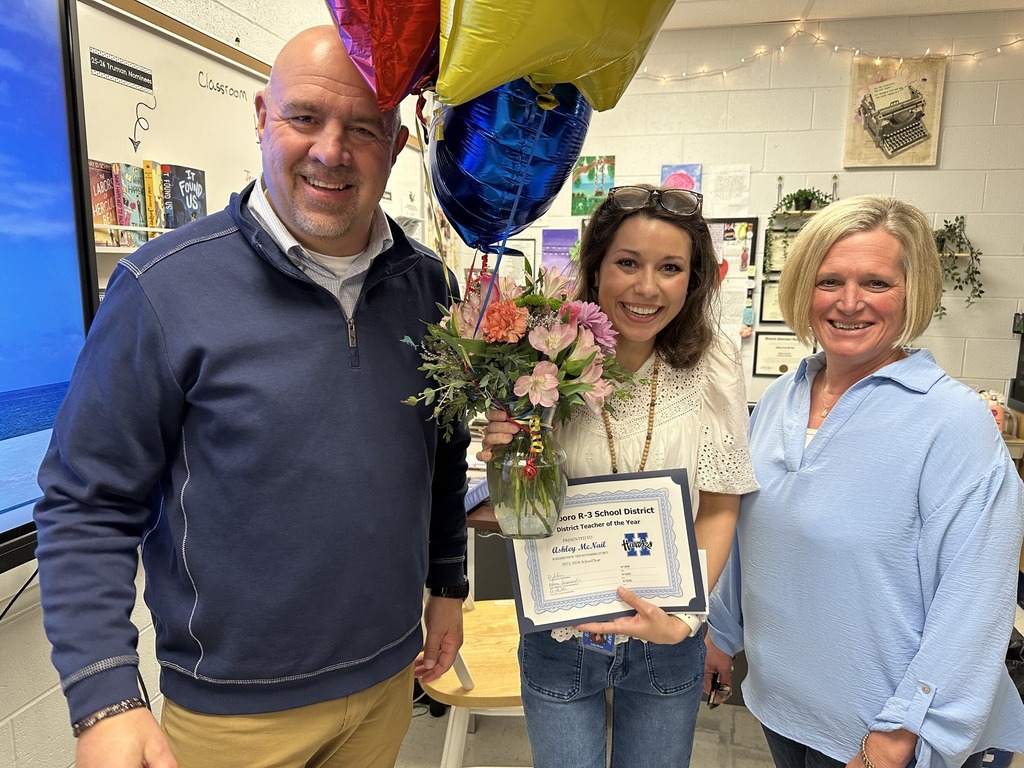 Image of Superintendent Dr. Jon Isaacson, Mrs. Ashley McNail and Assistant Superintendent Melissa Hildebrand moments after McNail was officially named District Teacher of the Year. 