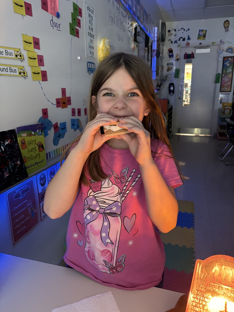 Student eating a s'more