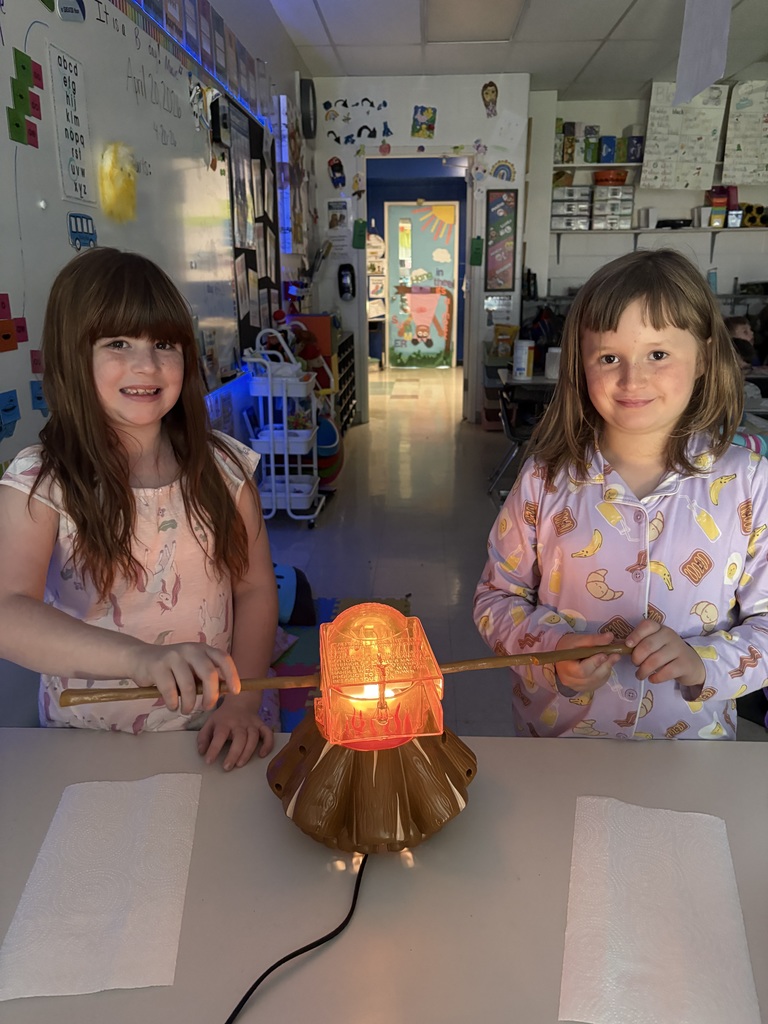 Two students smiling and making s'mores