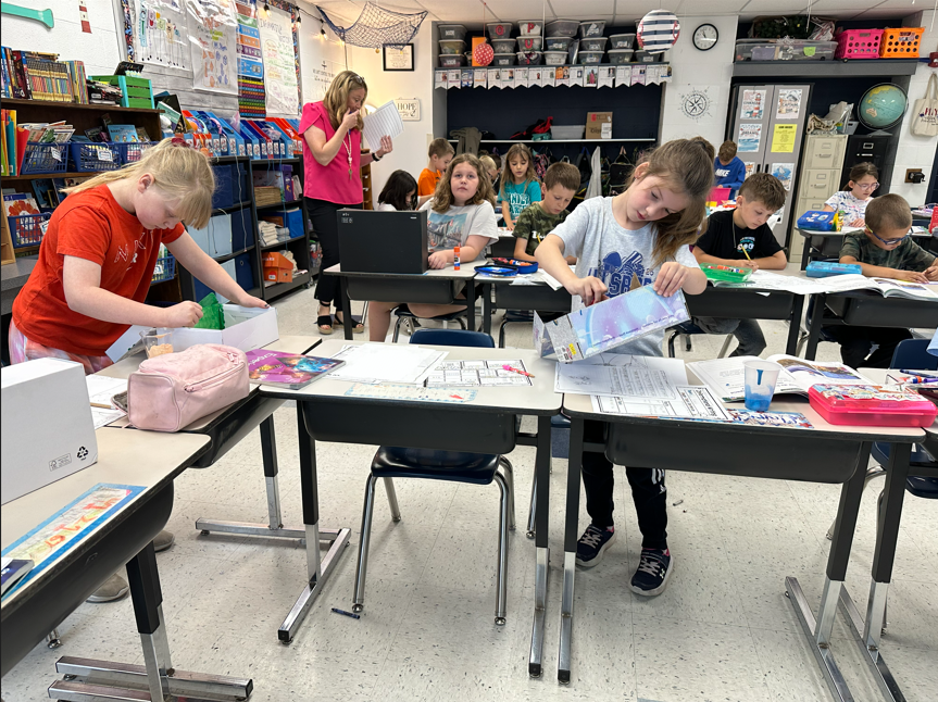 wide angle view of student concentrating on painting their class projects. Building animal habitats.