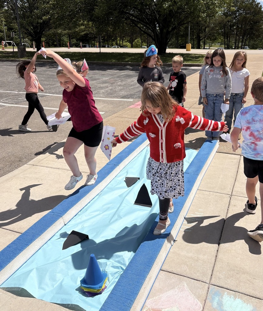 Children walking the plank avoiding "sharks" at the end of a unit.