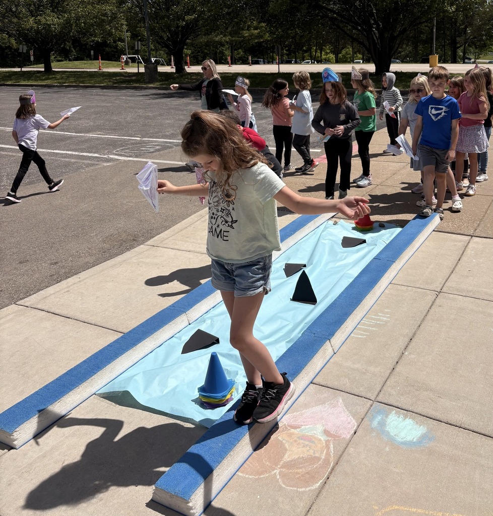 Children walking the plank avoiding "sharks" at the end of a unit.