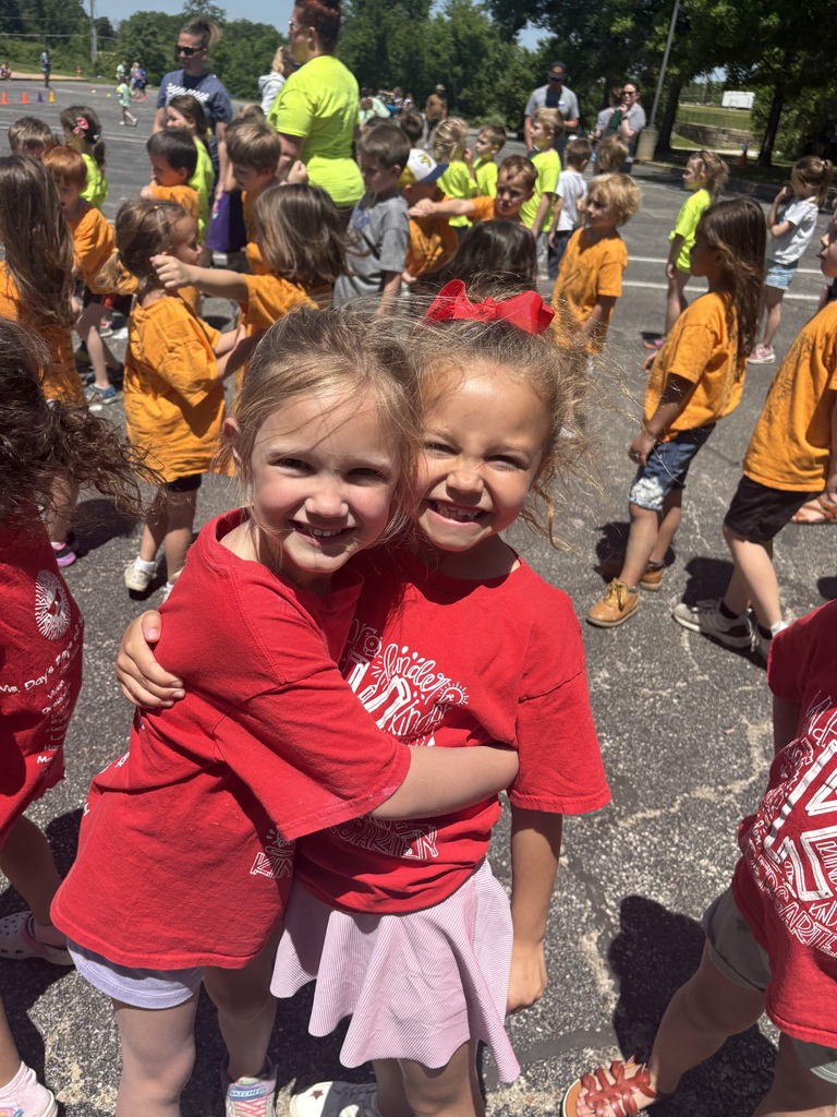 image is of two students smiling at the camera during field day at the primary school