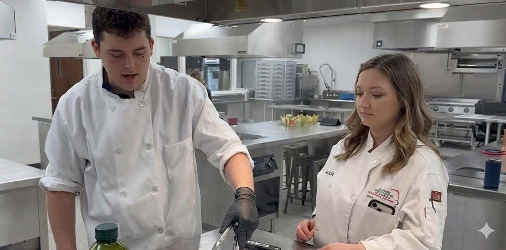 Picture of a student working with a teacher in the new kitchen at school