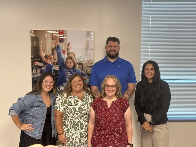 5 people smiling for the camera as they prepare to teach high school students at Hillsboro High School