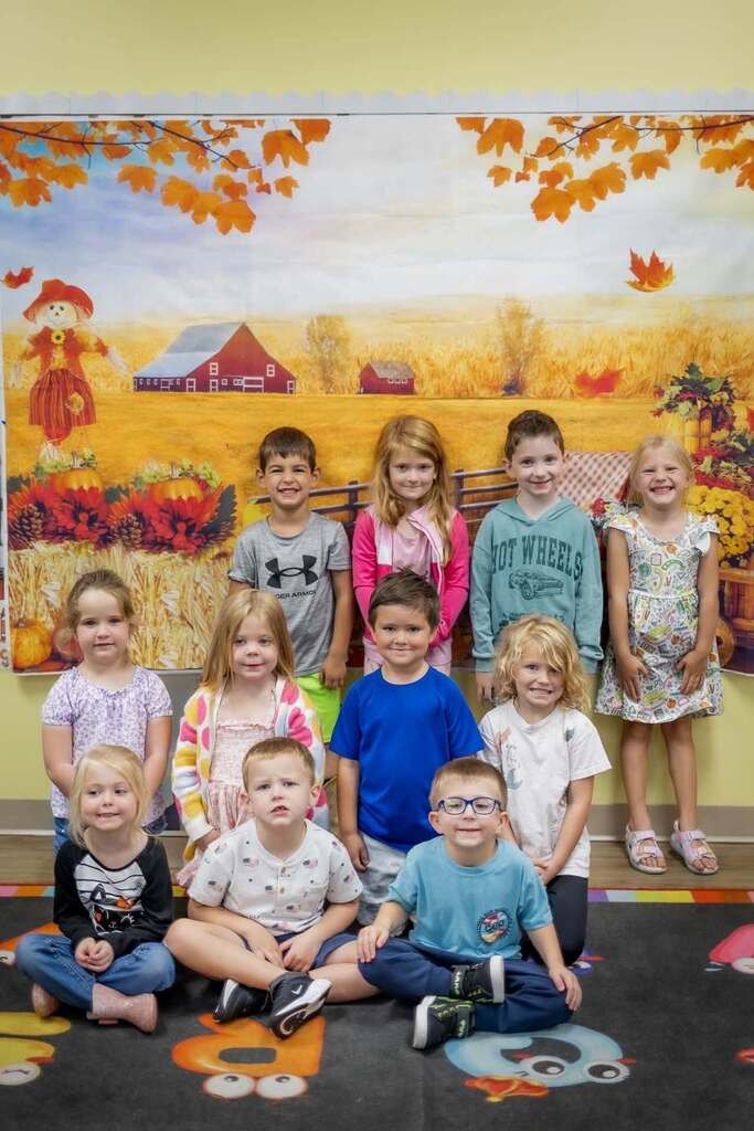 students smile at the camera. 