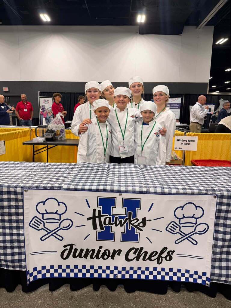 students smile at camera during junior chefs competition