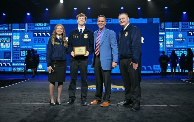 HCPS FFA Members at a convention on stage receiving an award.