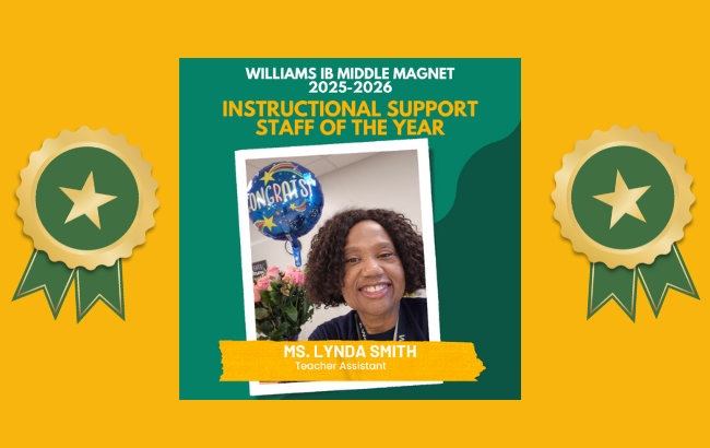 person with black blouse and curly hair smiling at the camera; boquet of pink flowers and blue balloon with stars and rainbows in the background