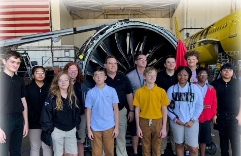 Brainard Harris's Aerospace Class in from of engine being repair at PEMCO Tampa