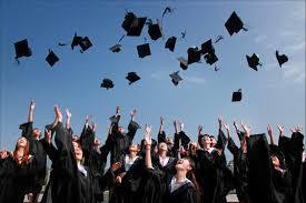 students tossing graduation caps in the air