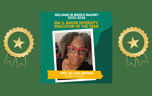 person with black blouse, pearl earings and necklace, and red glasses