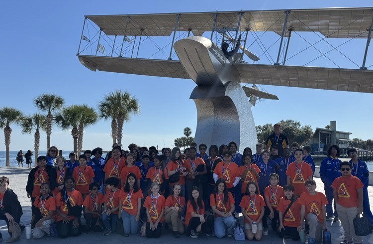 John Glenn Top Gun Academy students group photo in front of Tony Janus monument on St. Pete pier