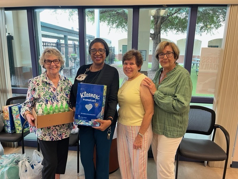 Sertoma Tampa Gem ladies making a donation of cleaning supplies