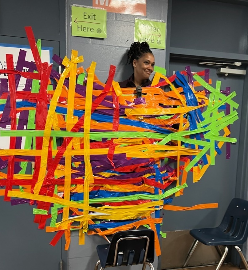 Ms. Webster taped to the cafeteria wall