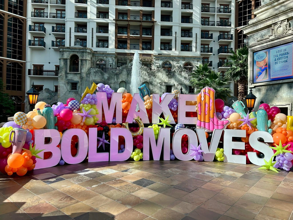 a sign with balloons that says Make Bold Moves