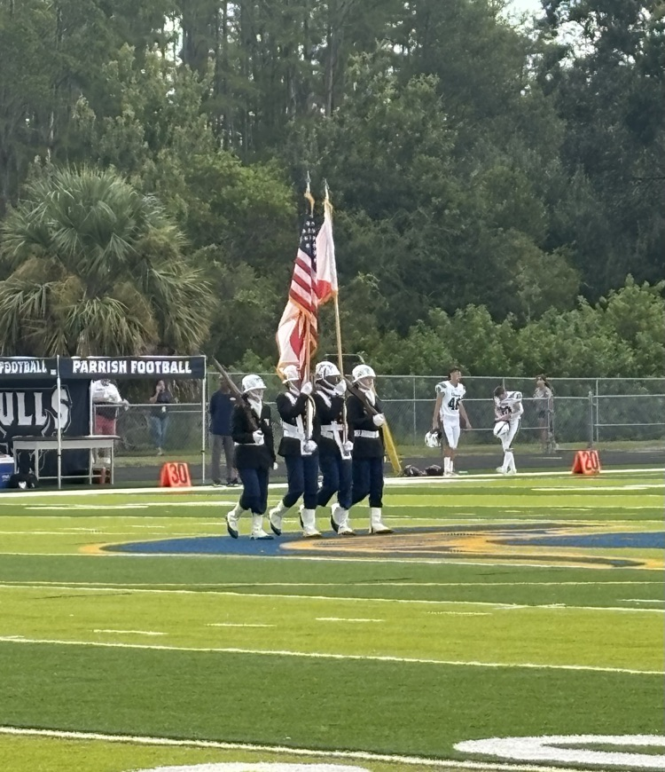 JROTC takes the field for the National Anthem.